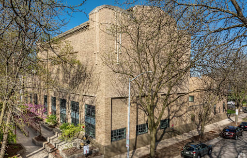 A large building with a flat roof and a brick facade.
