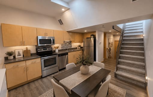 A modern kitchen with a dining table and chairs.