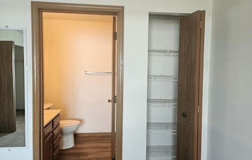 A bathroom with a toilet and a towel rack.