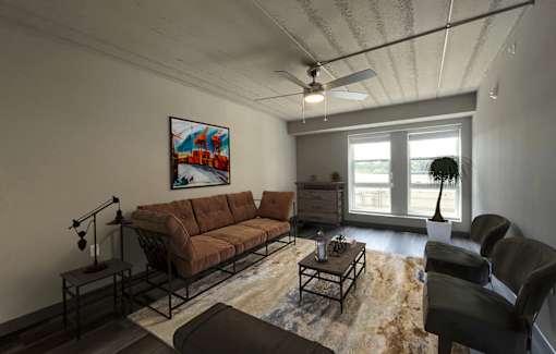 an empty living room with a ceiling fan