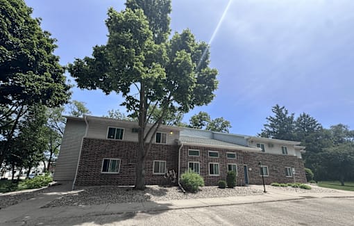 A house with a tree in front of it.