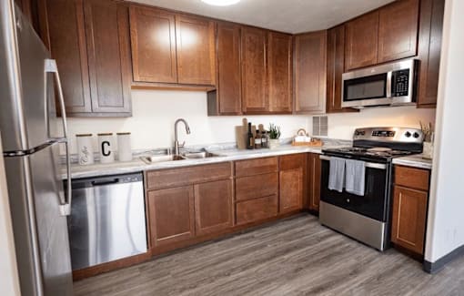A kitchen with wooden cabinets and stainless steel appliances.