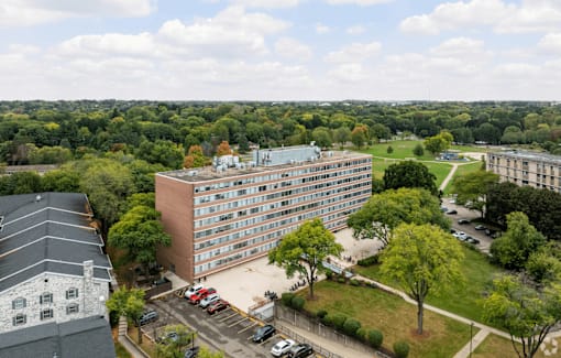 A large building with a parking lot in front of it.