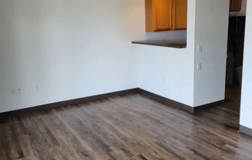 A room with wooden floors and white walls.