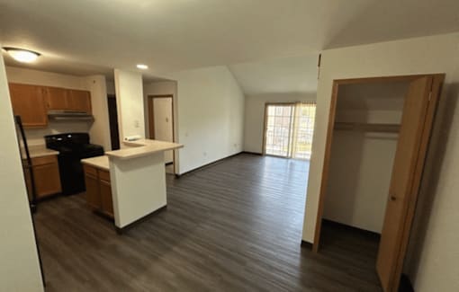 A kitchen with a white counter and wooden cabinets.