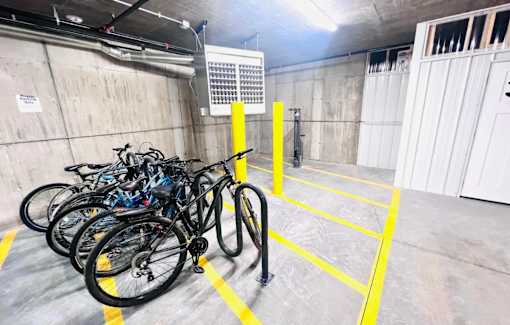 a row of bikes parked in a parking garage