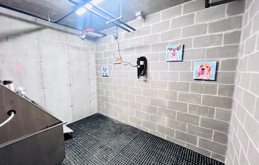a white tiled bathroom with a sink and a urinal
