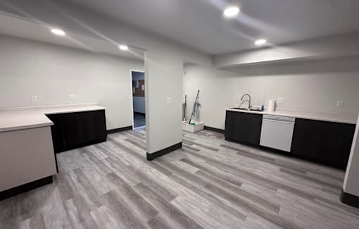 A room with a grey floor and white walls.