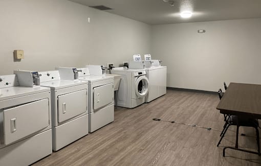 A laundry room with washers and dryers.