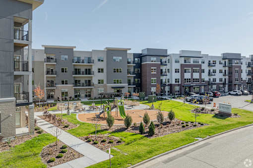Apartment complex with a playground in the front.