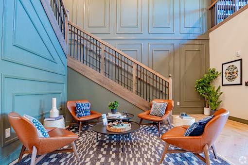 A living room with a staircase and a couch.