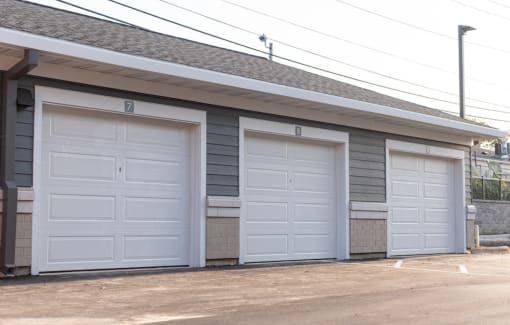 three garage doors on the side of a building