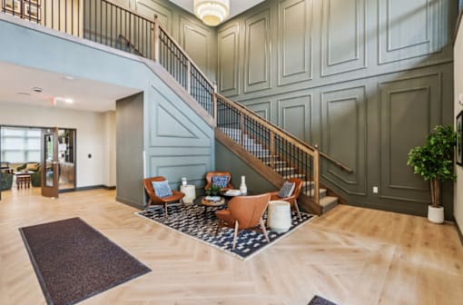 A spacious living room with a staircase and a dining area.
