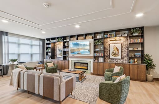 A living room with a fireplace, a couch, and a chair.