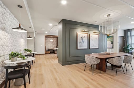 A modern dining room with a wooden table and chairs.