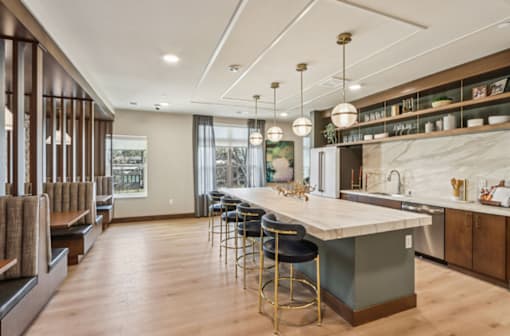 A modern kitchen with a large island and bar stools.