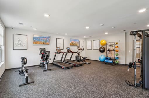 A spacious home gym with a variety of exercise equipment.