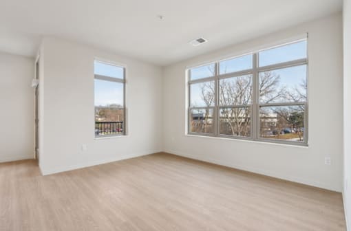 A room with a large window and a sliding glass door.