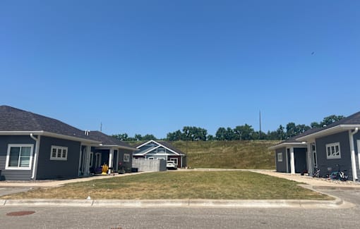 A row of houses with a clear blue sky above them.