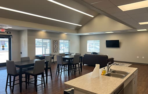A kitchen with a table and chairs in the middle of the room.