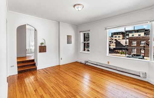 A room with wooden floors and white walls.