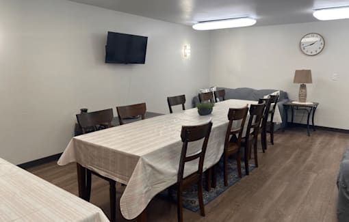 A conference room with a long table and chairs.