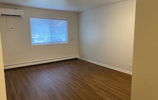 A room with a window and air conditioner.