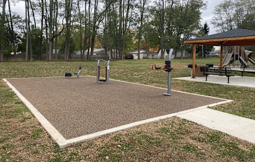 A playground with a swing set and a seesaw.