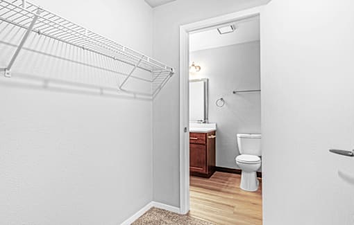 A white bathroom with a toilet and a walk-in shower.