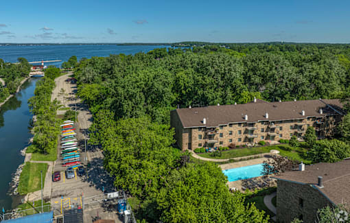 A view of a resort with a pool and a river.