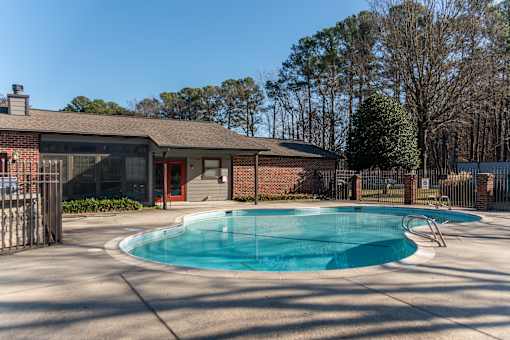 A small pool in front of a house.