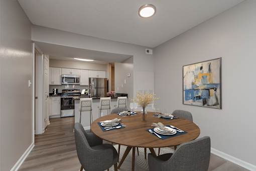 A dining room with a table set for six.