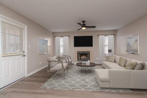 A living room with a fireplace and a television.