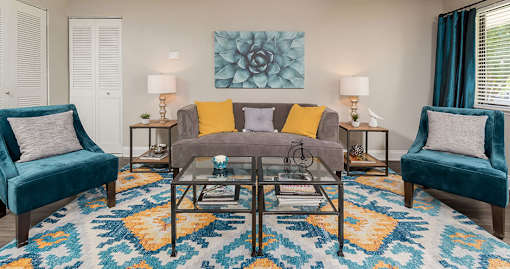 Living room with glass table and blue chairs