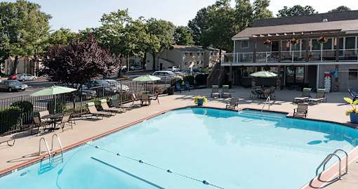 Pool deck with lounge chairs and view of clubhouse