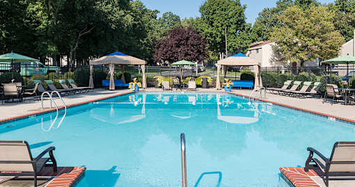 Pool with cabanas and lounge chairs