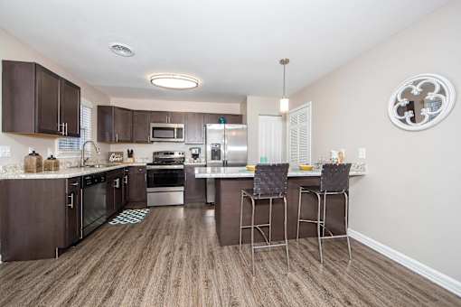 A kitchen with brown cabinets and a white ceiling.