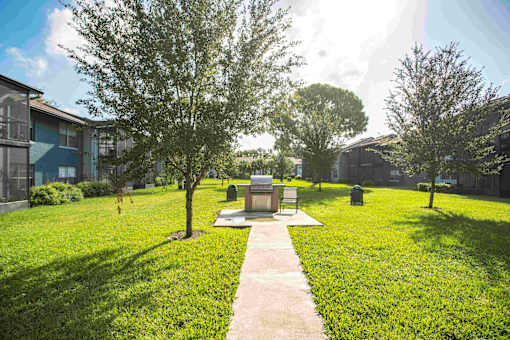A small monument sits in the middle of a grassy area.