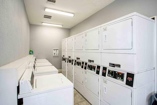 A row of washing machines in a laundromat.