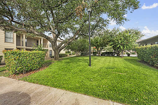 Courtyard with mature trees and lawn at Parks on the Green Apartments, Temple