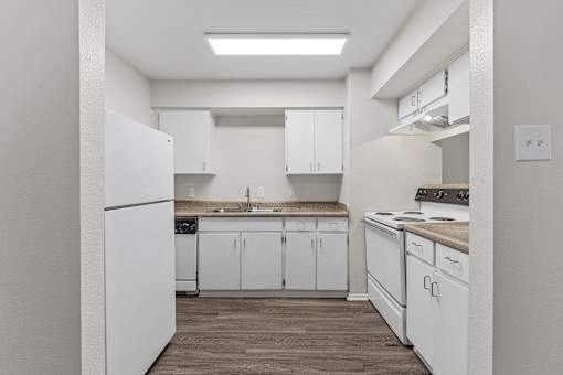 White kitchen with electric stove and skylight at Parks on the Green Apartments, Temple, TX