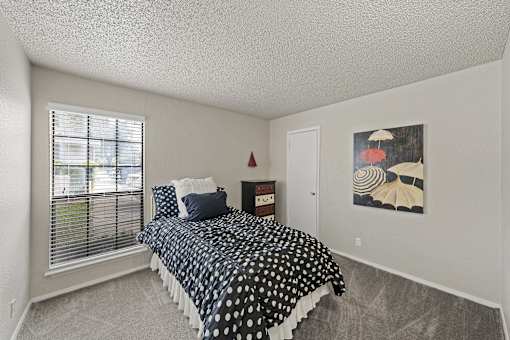Bedroom with polka dot bedding and window at Parks on the Green Apartments, Temple