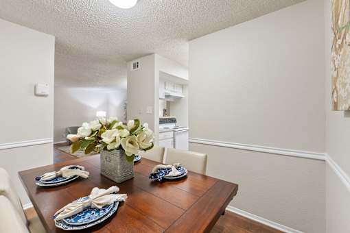 Dining room with wood table and place settings at Parks on the Green Apartments, Temple, TX 76504