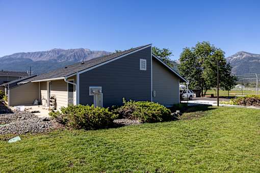 A house with a mountain in the background.