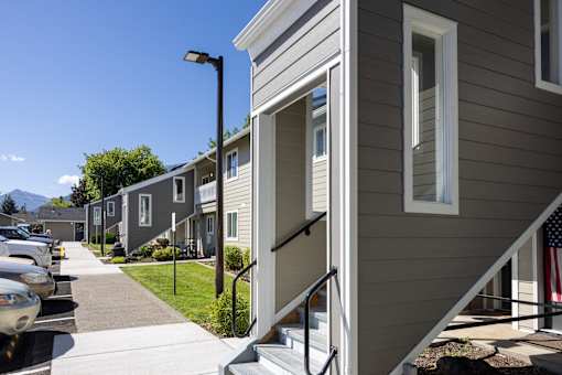 a row of houses on the side of a sidewalk