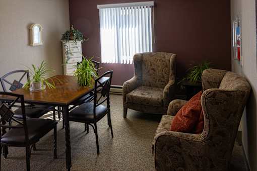 a living room with a dining room table and chairs