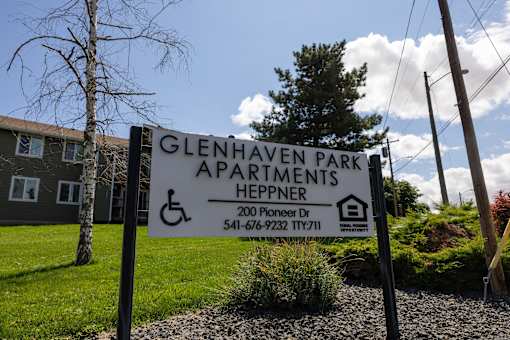 A sign for Glenhaven Park Apartments Heppner with a phone number on it.