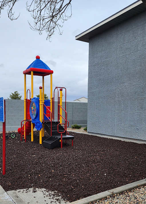 A playground with a blue and yellow structure.