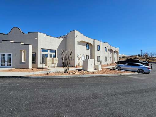 A modern building with a car parked in front.