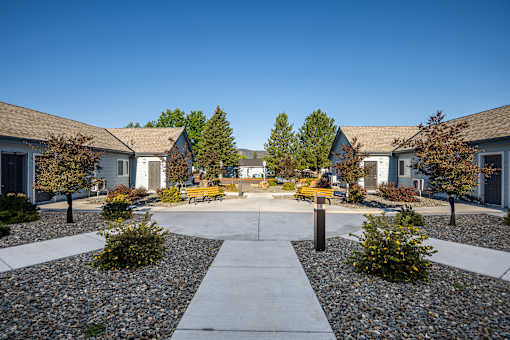 A courtyard surrounded by buildings with a clear blue sky above.